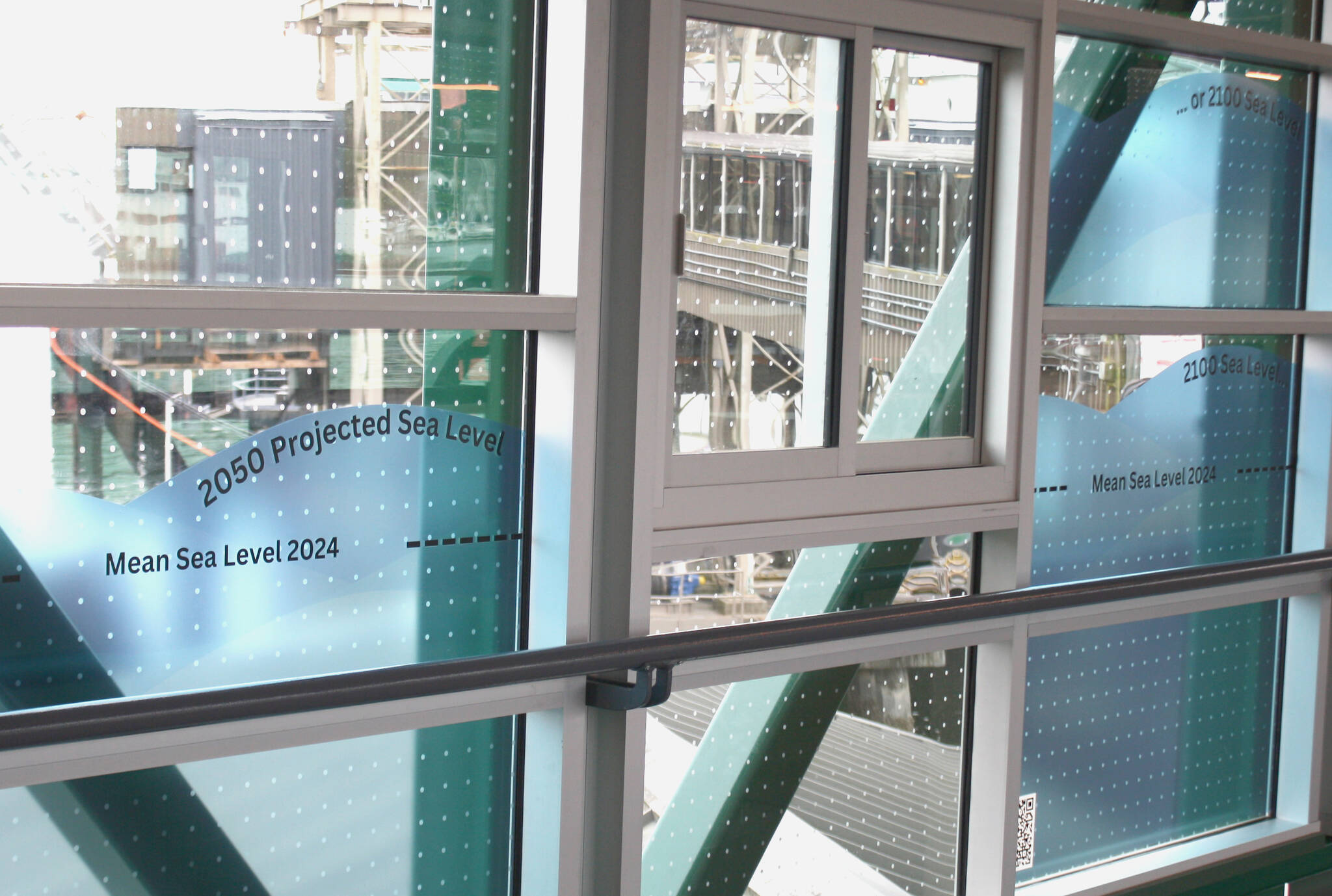 Three decals demonstrate the rate of sea level rise over 100 years.