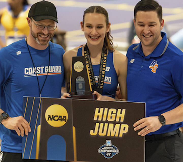 Allie Wildsmith accepts her national championship plaque surrounded by track coach Ethan Brown, left, and jumps coach John Jaskot.