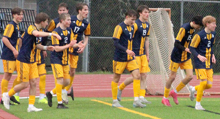 The Spartans celebrate a goal against Skyline March 20 at Bainbridge High School.