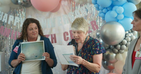 VMFH courtesy photos
Former nurse Julie Harper (center) reads a poem she wrote titled ‘Labor Room Walls’ at an event honoring the 25th anniversary of St. Michael Medical Center’s Family Birth Center July 8.