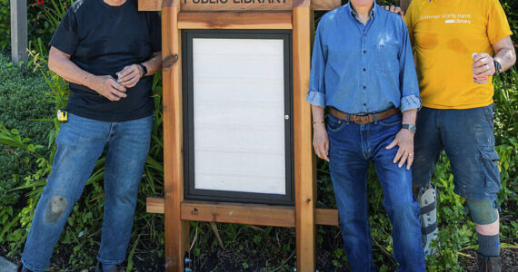 BARN courtesy photo
BARN volunteer David Grant (left) and Bainbridge Island library boardmembers Jim McKeever (center) and Kip Bankart (right) stand next to the newly constructed library sign.