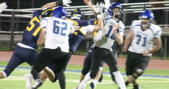 Luke Caputo/Kitsap News Group photos
Spartan defensive linemen Wyndham Kocenash and Kincaid Hopp attempt to bring down North Mason QB Danner Jones in a 28-14 Bainbridge home loss to the Bulldogs Oct. 4.