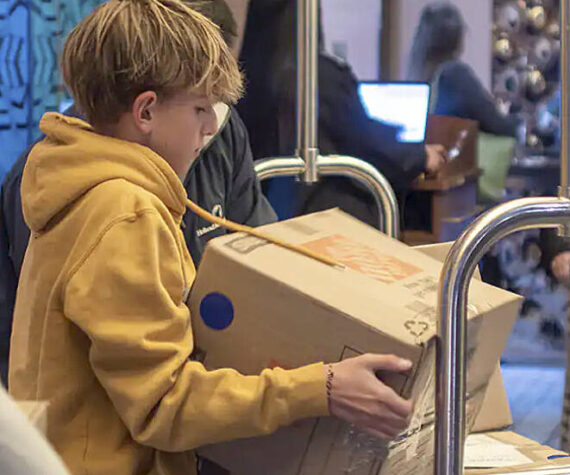 Holland America Line courtesy photo
An Odyssey Middle School student helps load a box of supplies on the ship Noordam, which will be en route to underserved schools in the Solomon Islands.