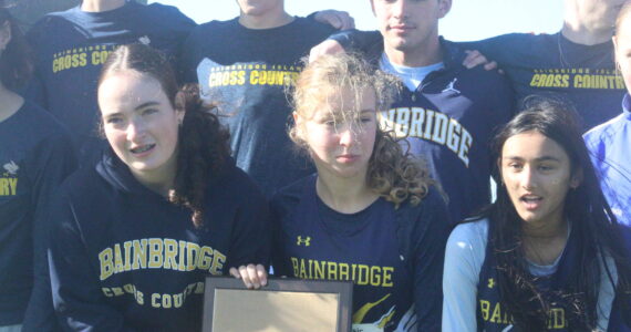 Luke Caputo/Kitsap News Group photos
Members of the Bainbridge cross country team celebrate their first-place finish in both the boys and girls competition at the 2025 district cross country championships Nov. 1 in Tacoma.