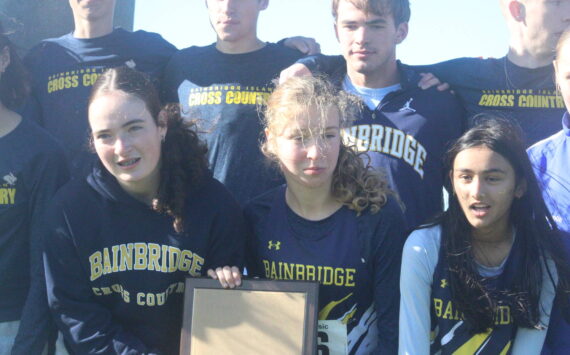 Luke Caputo/Kitsap News Group photos
Members of the Bainbridge cross country team celebrate their first-place finish in both the boys and girls competition at the 2025 district cross country championships Nov. 1 in Tacoma.
