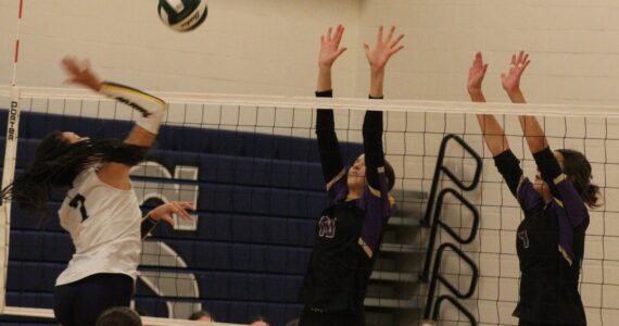 Luke Caputo/Kitsap News Group photos
Vikings Maci Anderson and Addison Jess prepare to block a spike from Spartan Zariyah Francis in a 3-0 Bainbridge win over North Kitsap Nov. 8 in the semifinals of the District 3 2A volleyball tournament at North Mason High School.