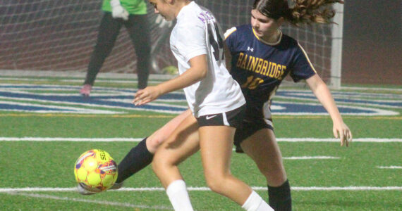 Luke Caputo/Kitsap News Group photos
Spartan Abril Edwards fights for the ball with an Anacortes player in a 4-3 Bainbridge home loss to the Anacortes Seahawks in the quarterfinals of the 2A girls state soccer tournament Nov. 15.