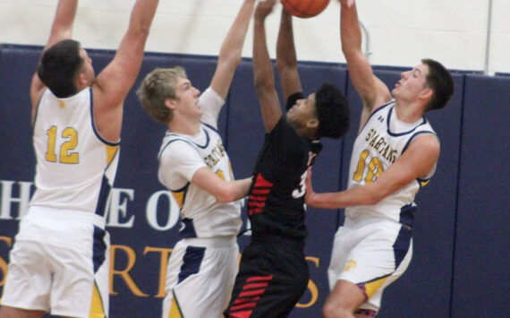Luke Caputo/Kitsap News Group photos
Spartan Ryan Rohrbacher blocks a Palm Springs player’s shot with Will Rohrbacher and Lane McFadden defending in a 64-58 Bainbridge home win against Palm Springs Dec. 3.