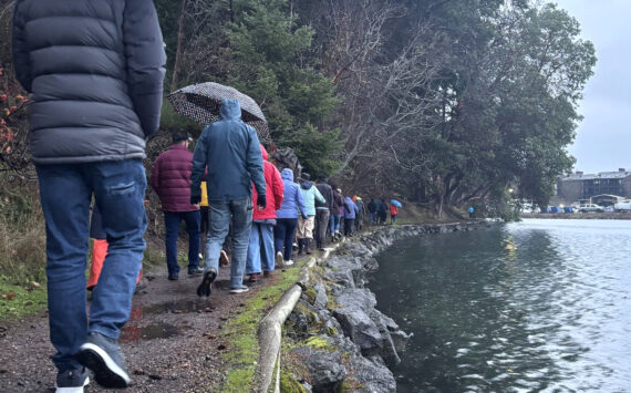 Molly Hetherwick/Kitsap News Group photos
King tide walk attendees stroll along the Waterfront Trail Dec. 8, next to an unusually high water level.