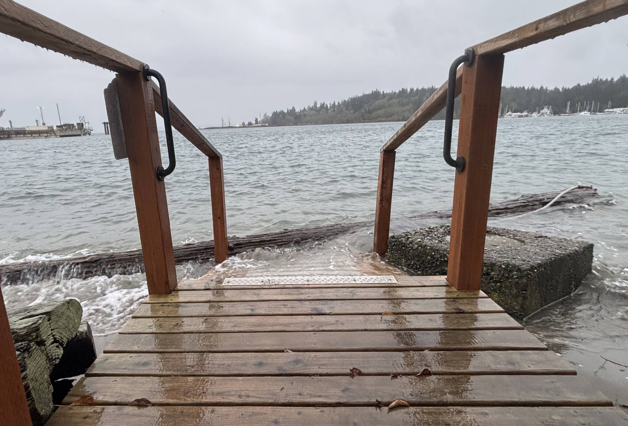 Waves from the highest point of the king tide lap over the accessible ramp to the private beach at Eagle Harbor condominiums Dec. 8.