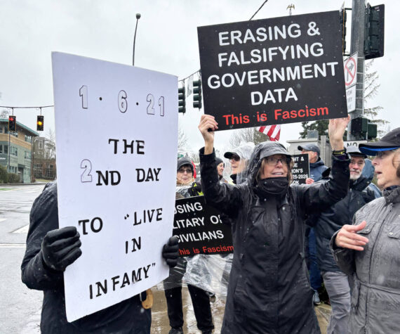 <p>Molly Hetherwick/Kitsap News Group photos</p>
                                <p>Protesters held waterproof signs to battle the weather at the corner of Highway 305 and Winslow Way Jan. 6.</p>