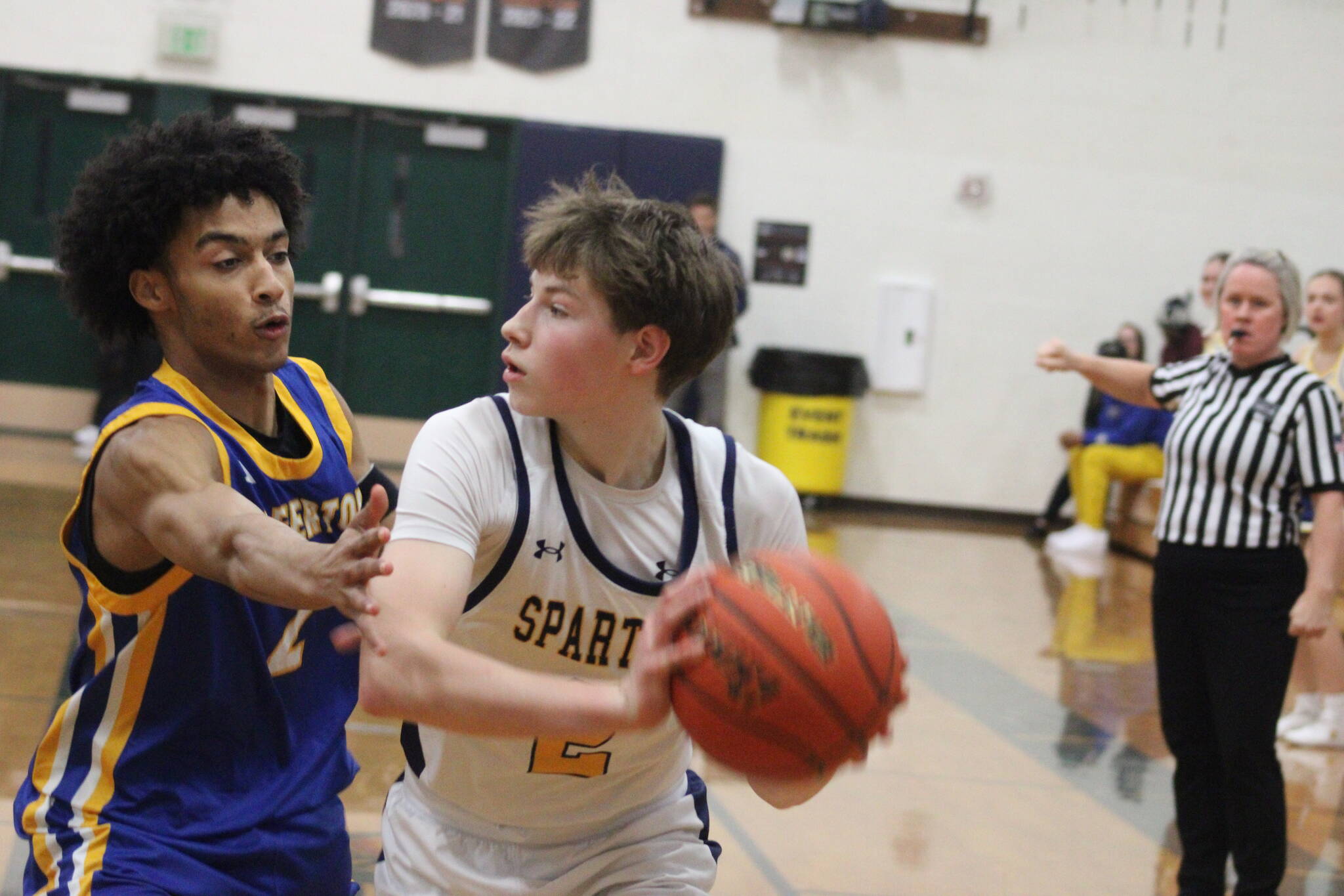 Spartan Julien Zupan looks to make a pass with Knight Aaron Matthews defending him in an 84-41 Bainbridge home loss to Bremerton Jan. 27.