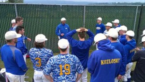 The Spartans gather for a post-game talk after their first win at Dream Field Saturday.