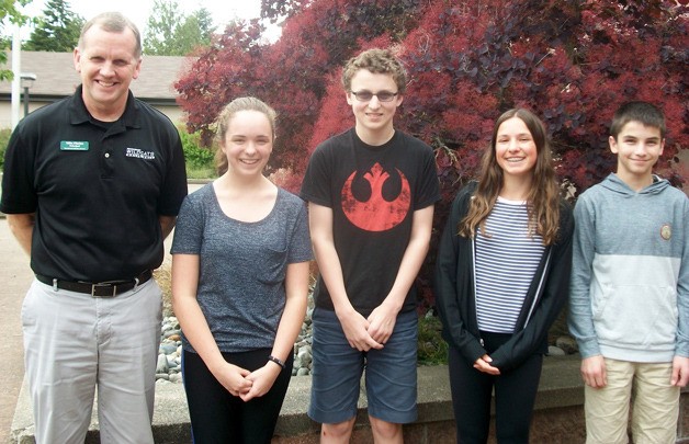 Woodward Middle School Principal Mike Florian stands with Student of the Month winners Cayley Mead