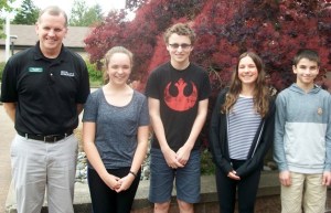 Woodward Middle School Principal Mike Florian stands with Student of the Month winners Cayley Mead