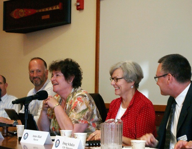 Bainbridge Island Mayor Anne Blair and City Manager Doug Schulze discuss traffic on Highway 305 with representatives of the city of Poulsbo and Suquamish Tribe.