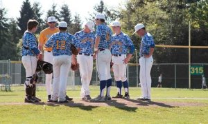 The BHS players on the field have a quick huddle with Spartan Head Coach Simon Pollack after trailing by two runs early in the first inning during the home game against Chief Sealth. The visitors' lead was not to last