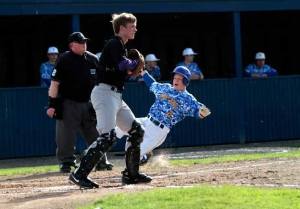 Carter Kraus slides into home during last week’s game against Garfield.