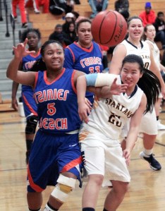 BHS junior guard Sydney Gibbs struggles for the ball against R. Beach's Kamarea Jenkins at the Spartan home game Friday