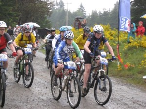 Anika Vroom (409) of the Bainbridge Gear Grinders maintains her position at the front of the pack during a mountain bike race during the Gear Grinders's last season.