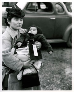 Fumiko Nishinaka Hayashida holds her 13-month-old daughter Natalie as she waits with other Japanese American residents of Bainbridge Island at the Eagledale Ferry Landing to be taken off Bainbridge and sent to an internment camp in March 1942.