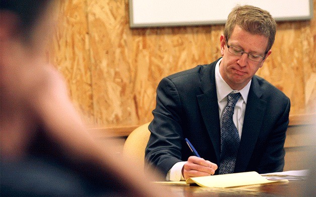 Congressman Derek Kilmer jots down notes during an environmental roundtable last week at IslandWood.