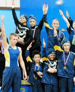 The Bainbridge Island Level 5 gymnasts celebrate their first-place team finish.
