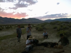 Scott Blake stands with his eyes in a viewfinder on the set of “The Surveyor.” With him are (from left) Darren Haffner