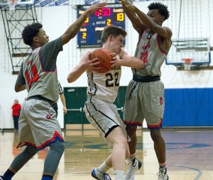BHS junior Brendan Burke thrashes his way free from a tag team attack by Rainier Beach defenders during Friday’s home game.