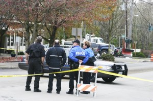 Bainbridge fire and police personnel await the arrival of WSP-Bremerton's 'bomb squad' Monday after a woman brought a small safe to the police station that had traces of nitroglycerin detected on its exterior. The three-hour event delayed traffic on Winslow Way and State Route 305 until the empty safe was removed from the woman's vehicle (brown SUV's tailgate in background) and transported off the island.