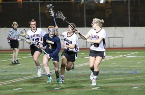 Defender Maggie Sweeney picks up a ground ball during Bainbridge's win over Mercer Island.