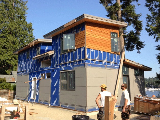 Workers stand at the installation site of a new green home built Method Homes on NE Ewing Street. The installation was the company's first on Bainbridge Island.
