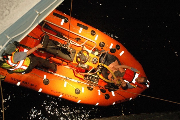 A rescue crew from the ferry M/V Wenatchee gives aid to a woman who was saved after she went overboard from the ferry late Saturday.