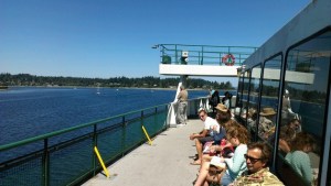 Passengers aboard the ferry MV Tacoma wait on the upper deck for a tugboat as the ferry sits at anchor outside Eagle Harbor Tuesday.