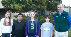 Woodward Middle School Principal Mike Florian stands with Students of the Month Mackenzie Chapman