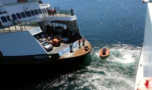 A crew from the ferry MV Sealth brings a tow line to the ferry MV Tacoma. The Tacoma lost propulsion power on its sailing to Bainbridge Island Tuesday afternoon.
