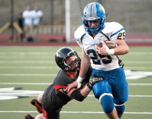 Spartan running back Sam Wysong blazes through the first-wave of Cougar defense during the first game of the season. Despite a late fourth-quarter rally