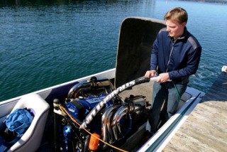 Todd Hansen prepares a water ski tow rope on the InTheWorks company boat.
