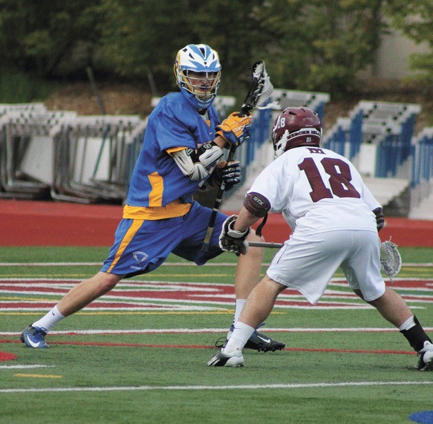 Jacob Knostman of the Bainbridge High Spartans looks to move upfield against Islander Devlin Conway in Wednesday’s state semifinal matchup at Mercer Island.