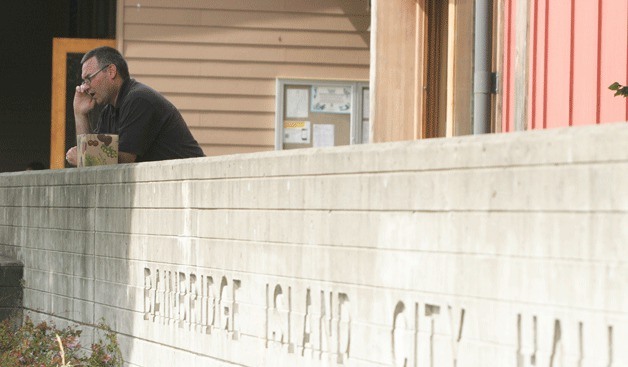 City Manager Doug Schulze gets caught up with city business on his cell phone during a lunchtime break Tuesday from the first round of 'high performance organization' training.
