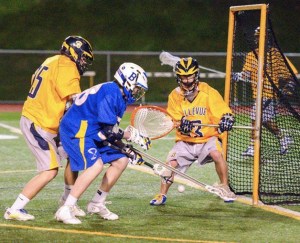 Bellevue and Bainbridge players scramble for a loose ball in front of the Wolverines' net in high school lacrosse action Friday at Bellevue High School.