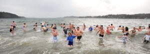 About 100 people showed up at noon to ring in the new year by running into frigid waters off the Lytle Road beach access. The annual tradition celebrated it's 10th year.