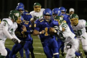 Spartan running back Ross Cobb punches through a hole in the Blanchet defense Friday.