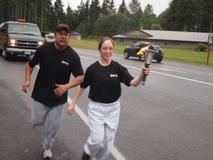 Island police carry the torch.