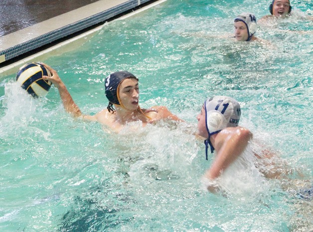 Jack Kapel fends off the defenses of the visitors from Stadium High and looks toward the goal during last week's home match.