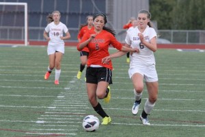 MacKenzie Chapman puts pressure on a Cougar midfielder during the Spartans’ 6-3 win.
