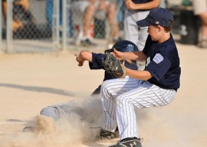 Yankees pitcher Duncan McCombs atttempts a home plate tag against Red Sox player Cody Hawken Wednesday at Rotary Field. The Red Sox advanced by defeating the Yankees 14-6.