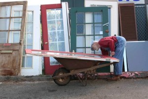 Volunteer Andy Strom sorts through the collection of donated doors at the Rotary Auction and Rummage Sale.