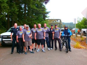 Bainbridge police gather at the north end of the Agate Pass Bridge after finishing their leg of the Torch Run.