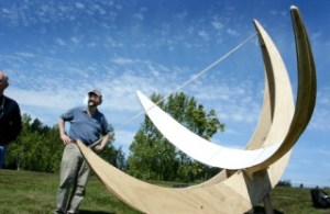 Bill Baran-Mickle stands by the temporary sundial sculpture Saturday.